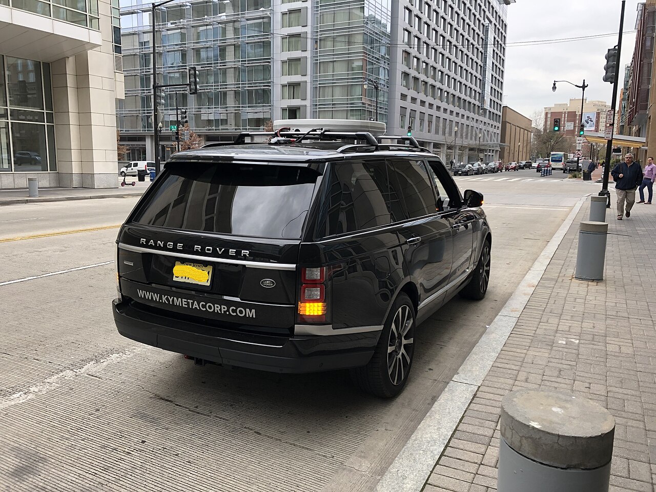 A flat, white, rectangular antenna mounted on the roof of a vehicle.