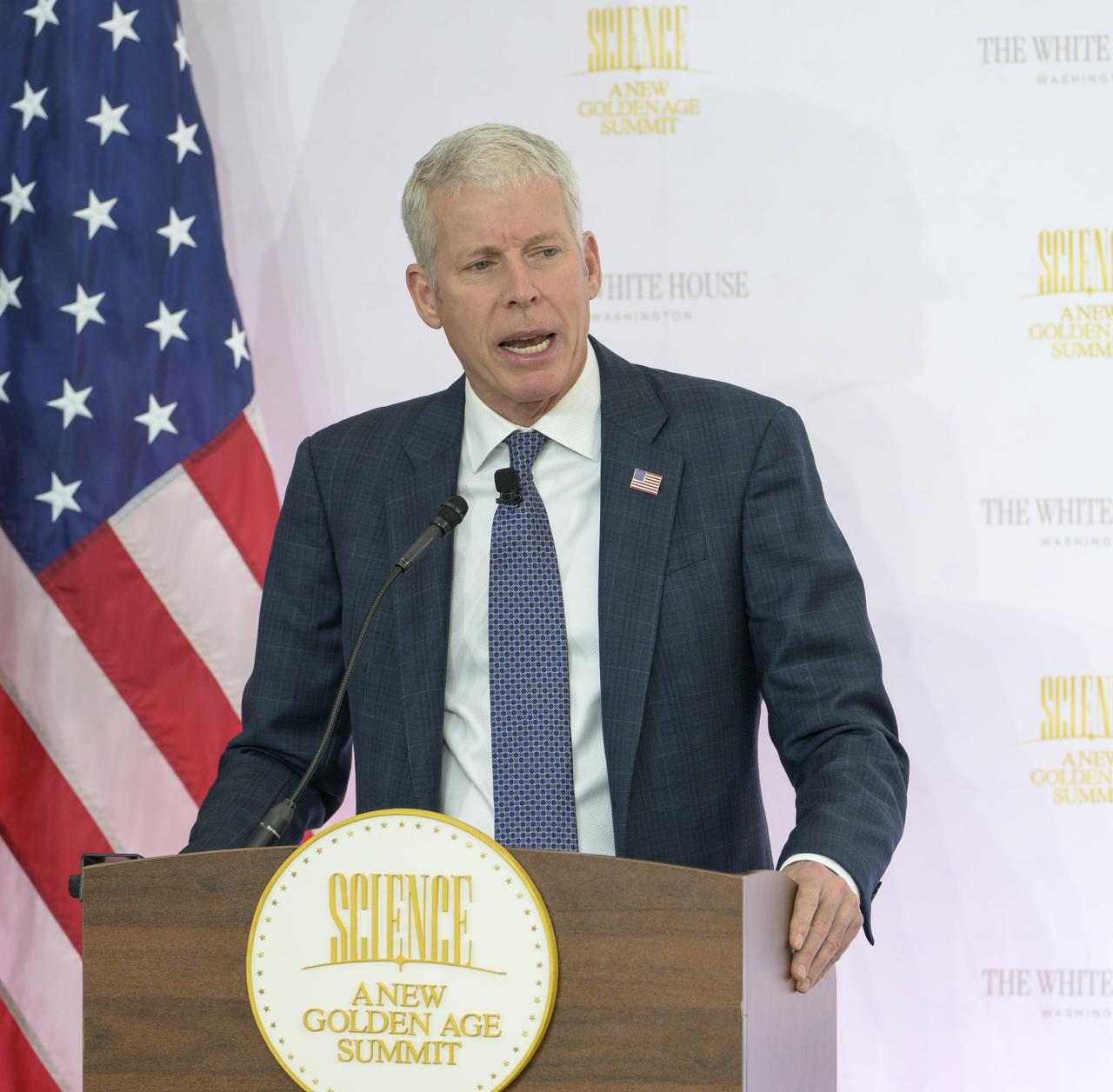 Chris Wright speaks at a podium.