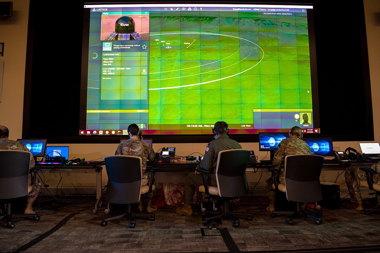 Airmen monitor computers in a control room.