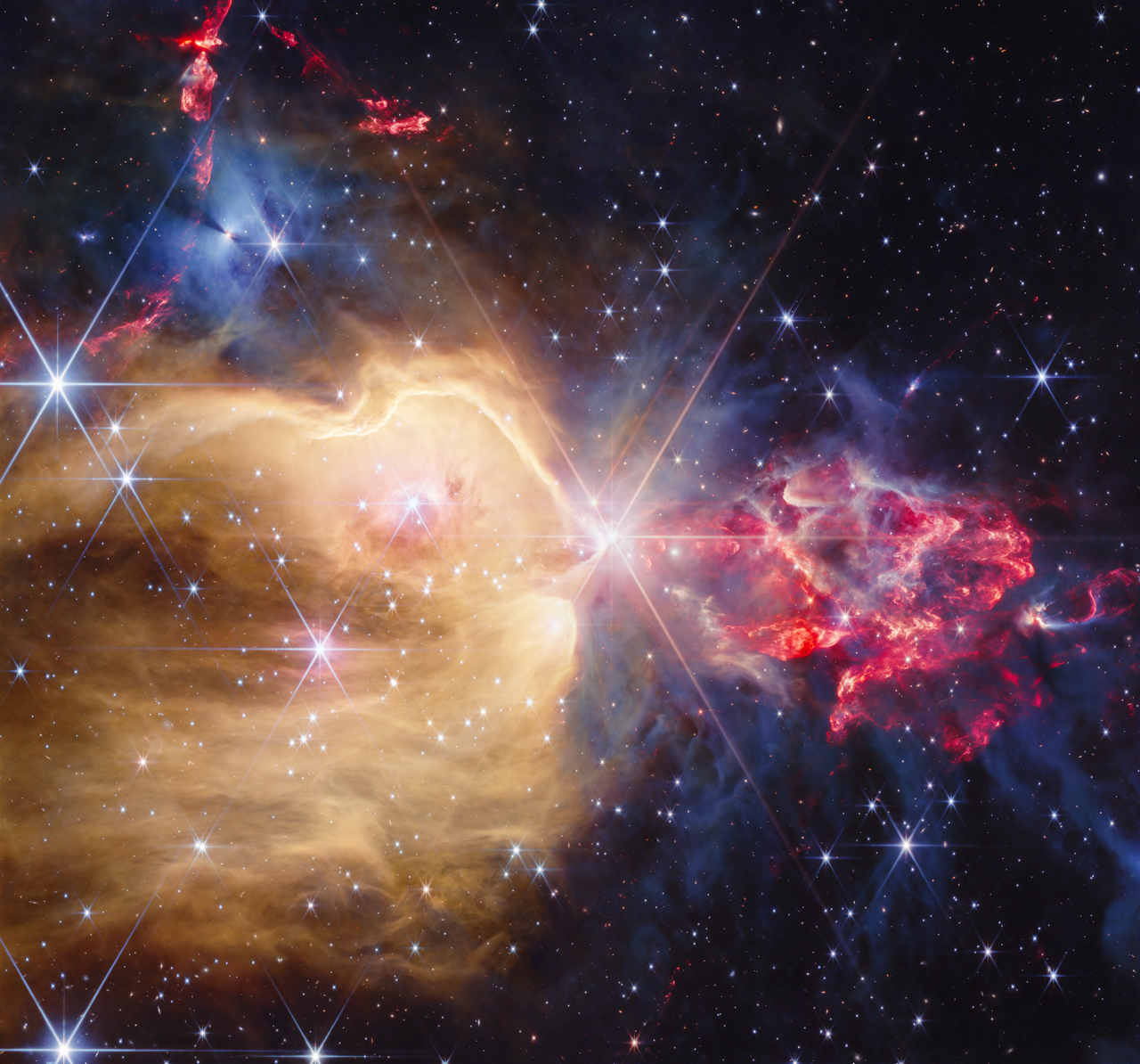 NGC 7129 in near-infrared light, showing protostars and glowing gases.
