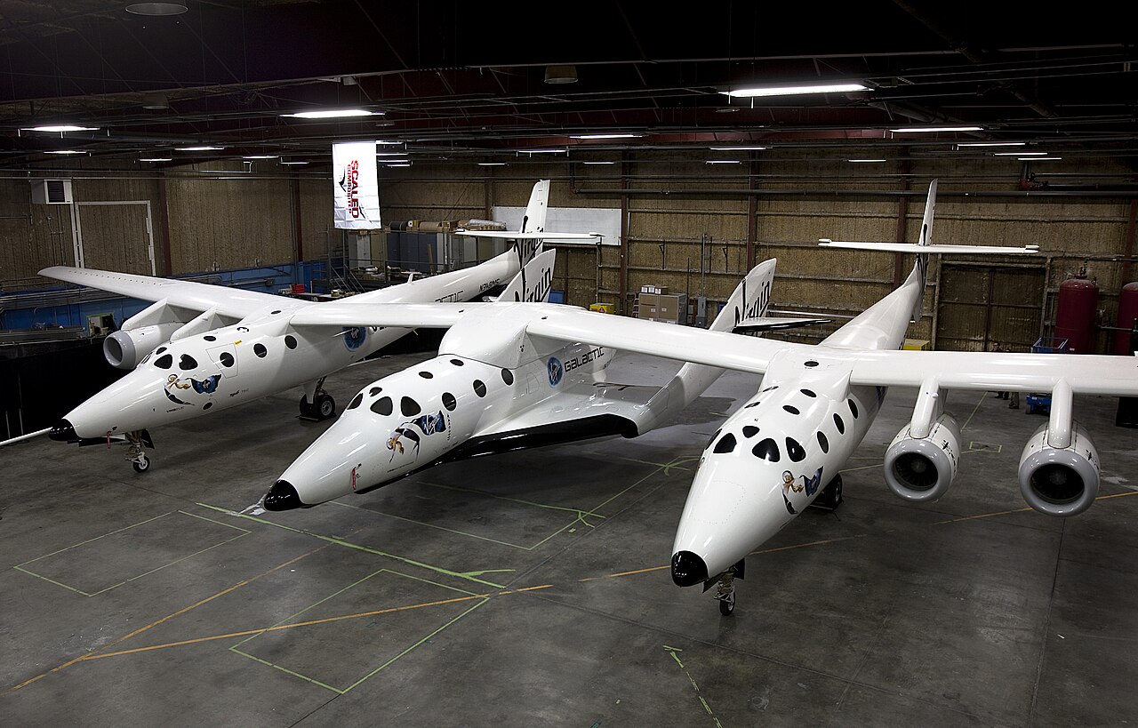 SpaceShipTwo spaceplane resting under its mothership, White Knight Two.